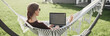 © kite_rin - Young beautiful woman in hammock working on laptop computer panoramic banner. Freelance, working from home, enjoy life, student lifestyle, distance studying, travel, online learning concept