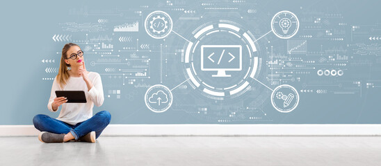 Web development concept with young woman holding a tablet computer