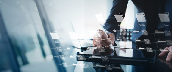 Wall Mural - business developer using digital tablet with kanban board framework on virtual modern computer displ