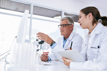 Poster - Bringing efficiency into their lab with cutting edge technology. Shot of two scientists working together on a computer in a lab.