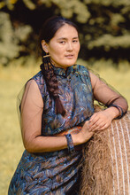 Young Mongolian Woman Wears Traditional Deel Dress. 