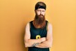 © Krakenimages.com - Redhead man with long beard wearing basketball uniform skeptic and nervous, disapproving expression on face with crossed arms. negative person.