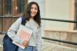 © Krakenimages.com - Young middle east student girl smiling happy holding book at the city.