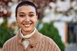 © Krakenimages.com - Beautiful hispanic woman with short hair smiling happy outdoors
