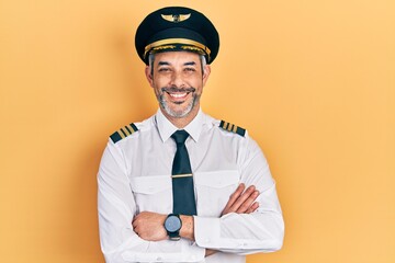 Poster - Handsome middle age man with grey hair wearing airplane pilot uniform happy face smiling with crossed arms looking at the camera. positive person.