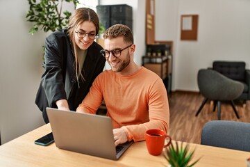 Canvas Print - Two caucasian business executives working and drinking coffee at the office.