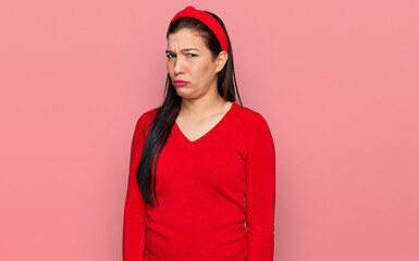 Sticker - Young hispanic woman wearing casual clothes skeptic and nervous, frowning upset because of problem. negative person.