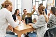 © Krakenimages.com - Two workers smiling happy high five during meeting at the office.