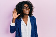 Young African American Woman Wearing Business Clothes And Glasses Waiving Saying Hello Happy And Smiling, Friendly Welcome Gesture