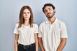 © Krakenimages.com - Young couple wearing casual clothes standing together relaxed with serious expression on face. simple and natural looking at the camera.