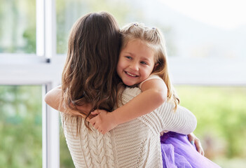 Poster - I love her little hugs. Shot of a little girl giving her mother a hug at home.