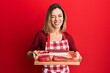 © Krakenimages.com - Young caucasian blonde woman holding board with raw meat winking looking at the camera with sexy expression, cheerful and happy face.