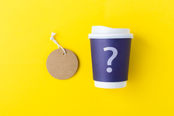 Wall Mural - blue paper coffee cup mockup with question mark and tag label on yellow background