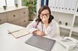 © Krakenimages.com - Down syndrome woman wearing doctor uniform stressed working at clinic