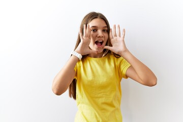 Sticker - Young brunette teenager standing together over isolated background smiling cheerful playing peek a boo with hands showing face. surprised and exited