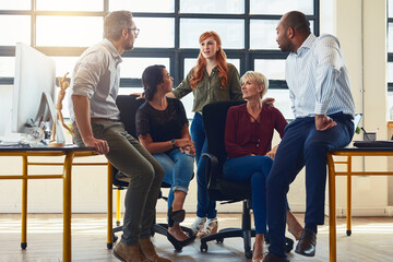 Wall Mural - Success is guaranteed when a team shares a collective vision. Shot of a group of designers having a discussion in an office.