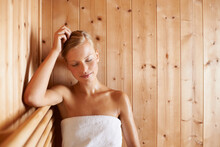This is her bliss. A gorgeous blond woman relaxing in a sauna.