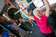 © Daniel Laflor/peopleimages.com - It doesnt get easier, you get stronger. Shot of a senior woman lifting weights while a group of people in the background watch on.