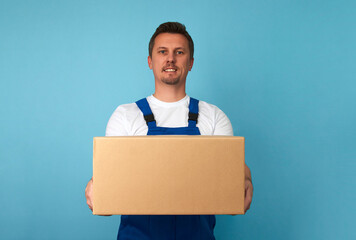 Delivery man with cardboard box on a blue background