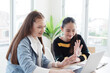 © cocorattanakorn - Smiling Caucasian student girls are online learning and calling conference with Laptop at home. They are talking and greeting with teacher on laptop together. Homeschool and Technology Concept.