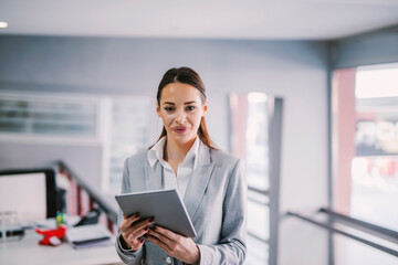 Wall Mural - Portrait of a businesswoman using tablet at office for work.