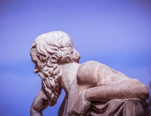 Socrates marble statue, the ancient Greek philosopher in deep thought, on blue sky background, Athens, Greece