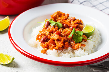 Wall Mural - Chili con carne - minced meat with vegetables and beans in tomato sauce with rice in bowl. Mexican food concept.