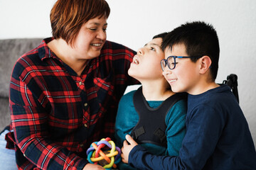 Happy mother having fun with her children indoor at home - Family moment - Focus on right son face