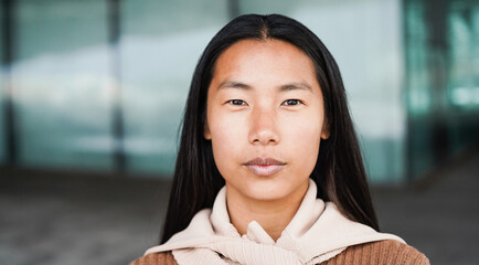 Portrait of asian girl looking at camera outdoor - Focus on face