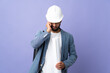 © luismolinero - Young architect Moroccan man with helmet and holding blueprints over isolated background frustrated and covering ears