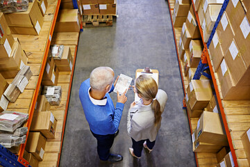 Poster - We take the guesswork out of shipping. High angle shot of a two managers working on a digital tablet in a warehouse.