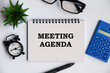 © Maurice Yom - Meeting agenda text on notepad with office concept background. Business concept