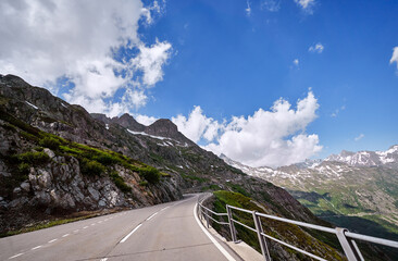 Asphalt road in Alp mountains. Road trip concept. Beautiful landscape.