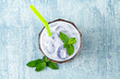 © yalcinsonat - refreshing blue coconut cocktail on blue stone background