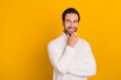 © deagreez - Photo of cheerful clever guy look empty space finger chin wear white sweater isolated yellow color background