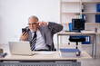 © Elnur - Old male employee working in the office