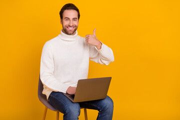 Sticker - Photo of reliable remote employee sit chair hold laptop raise thumb up wear white sweater isolated yellow color background