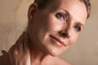 © D M/peopleimages.com - Relief from the days cares. Studio shot of a mature woman with beautiful skin.