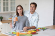 © BestForYou - Portrait young couple smiling and hugging in the kitchen great time together in the kitchen at home.