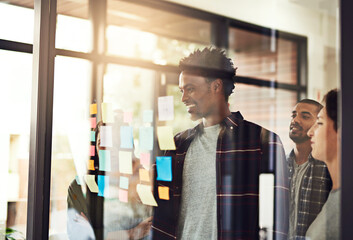 Aufkleber - It all starts with an idea. Cropped shot of coworkers using sticky notes on a glass wall during an office meeting.