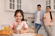 © New Africa - Internet addiction. Parents scolding their daughter while she using smartphone in kitchen