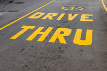 Drive Thru Sign Painted On Tarmac Of Local Business