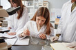 © Seventyfour - Front view portrait of young girl doing experiments in chemistry lab at school, copy space