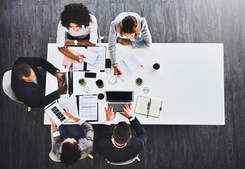 Sticker - Gaining a lead together. High angle shot of a group of businesspeople having a meeting in an office.