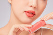 © Tuan  Nguyen  - Front view of model showing lipstick  with lip in white background for cosmetic advertising