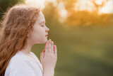 Fototapeta Dmuchawce - Little girl folded her hand in praying.