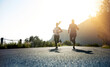 © Delmaine Donson/peopleimages.com - Theres one way to succeed and thats to give everything. Low angle shot of two people running on a tarmac road.