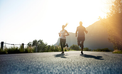 Poster - Theres one way to succeed and thats to give everything. Low angle shot of two people running on a tarmac road.
