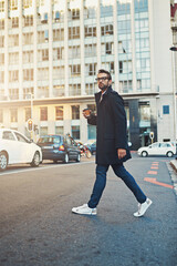 Sticker - Walking with purpose. Shot of a stylish man crossing a city street.