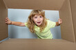 © Volodymyr - Happy child with cardboard box, unpacking parcel from internet store. Kids client satisfied with fast delivery service. Parcel packaging or unpacking concept.